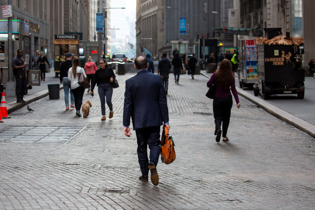 Pedestrians walk along Wall Street near the New York Stock Exchange (NYSE) in New York, as seen in June 2023. (Photographer: Michael Nagle—Bloomberg/Getty Images)