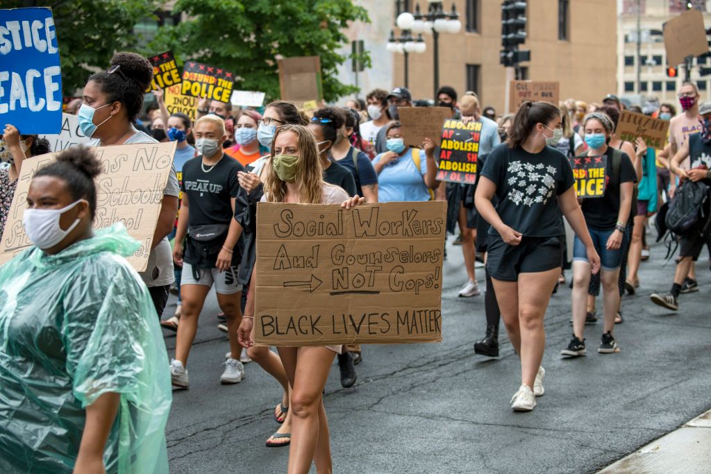 Protesters marching with signs in St. Paul, Minnesota, as seen in August 2020. (Photo by: Michael Siluk—Education Images/Universal Images Group/Getty Images)