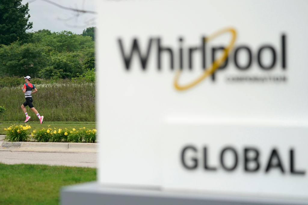 An athlete runs past a sign for the Whirlpool Global Headquarters as he competes during the run portion of the IRONMAN 70.3 Steelhead, as seen in June 2021. (Photo by Patrick McDermott/Getty Images for IRONMAN)