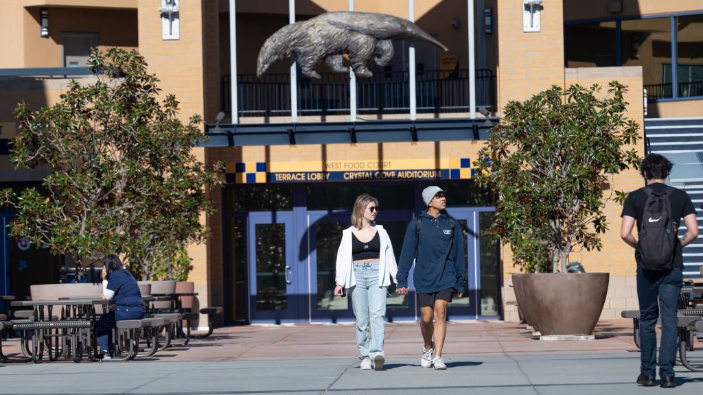 Two people walk at the University of California, Irvine campus, as seen in January 2022. (Photo by Paul Bersebach—MediaNews Group/Orange County Register/Getty Images)