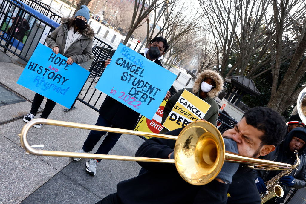 Student loan borrowers and the Too Much Talent Band thank President Joe Biden and Vice President Kamala Harris for extending the student loan pause and now demand that they cancel student debt at a gathering outside The White House, as seen in January 2022. (Photo by Paul Morigi/Getty Images for We, The 45 Million)