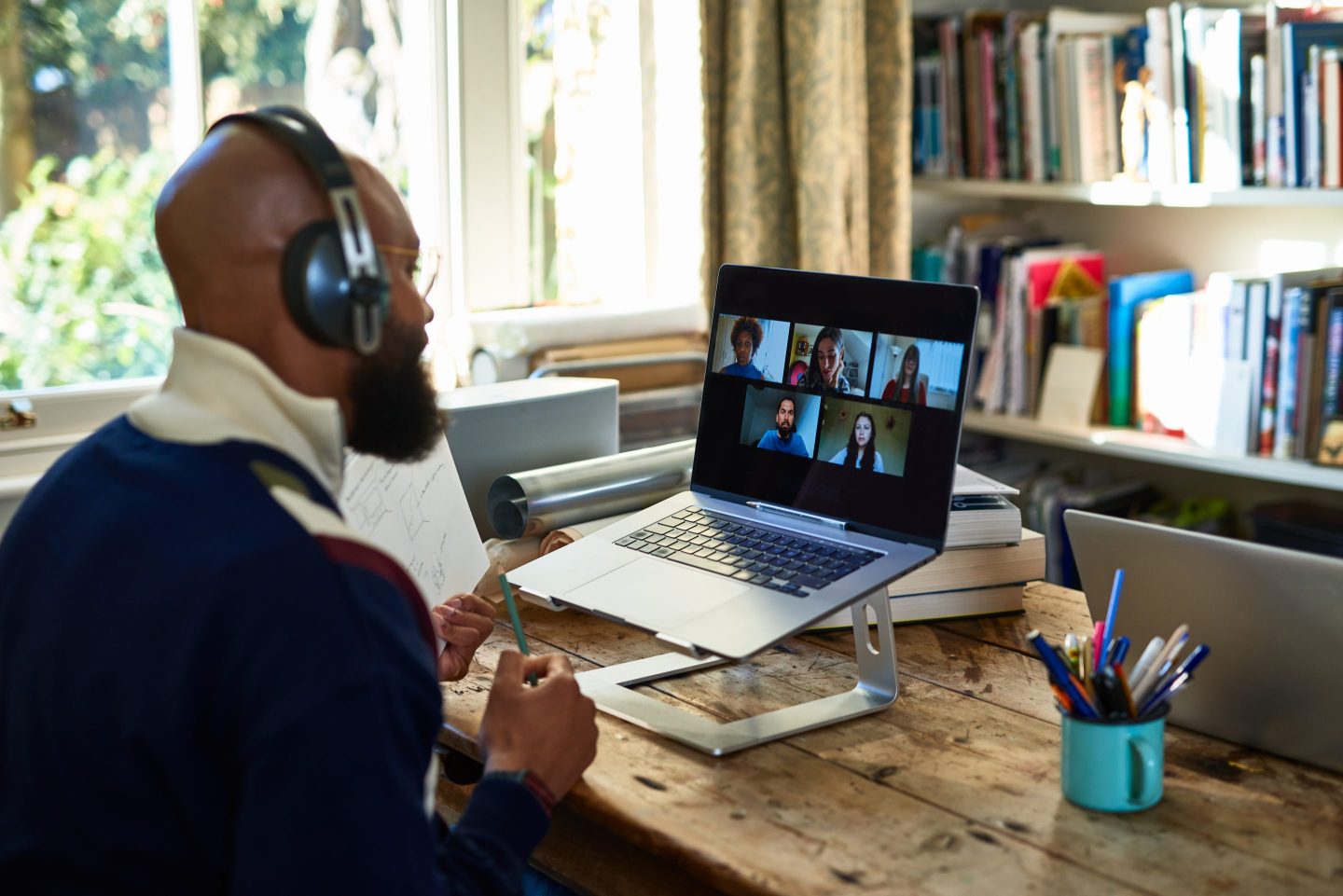 Man participates in a video work session from his home