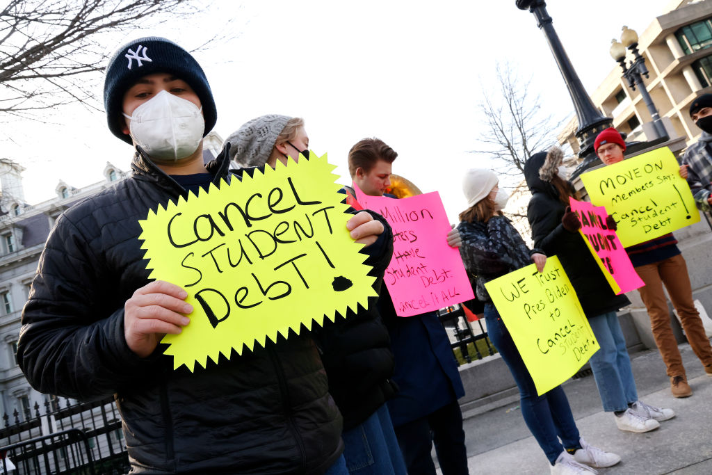 Demonstrators demand President Biden cancel student loan debt outside the White House in February 2022 in Washington, D.C.