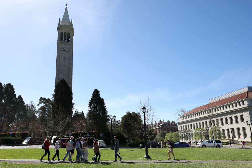 A group walks by Sather Tower on the UC Berkeley campus, as seen in March 2022. (Photo by Justin Sullivan/Getty Images)