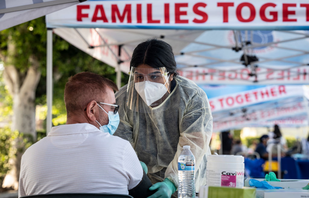 A medical assistant takes the blood pressure of a man at a monkeypox vaccination clinic at Families Together of Orange County in Tustin, California, as seen in August 2022. (Photo by Paul Bersebach—MediaNews Group/Orange County Register/Getty Images)