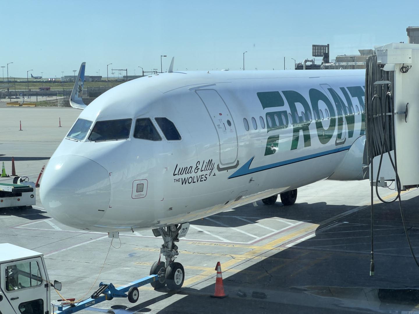 A Frontier Airlines plane sits at the gate at Denver International Airport