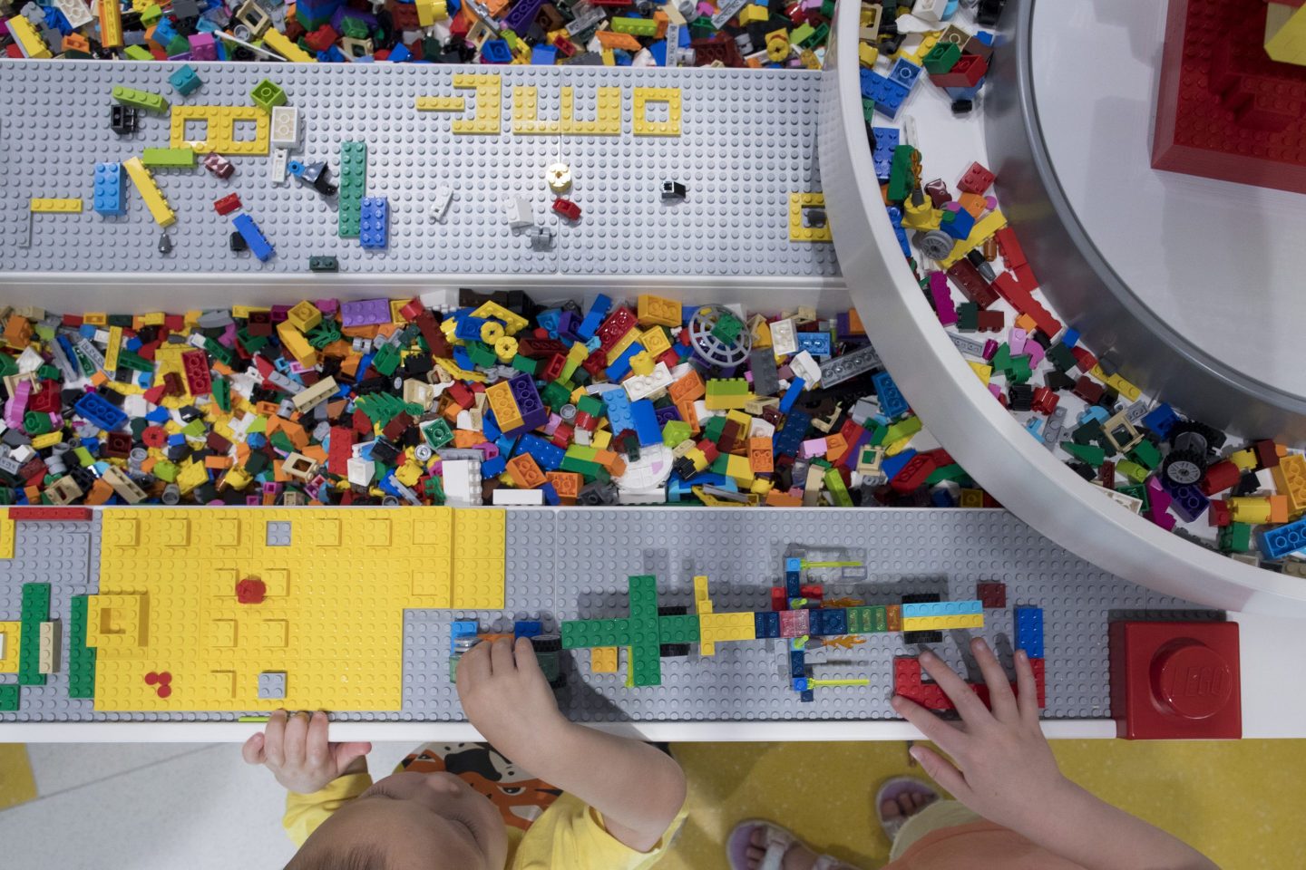 kids playing with a number of different lego bricks