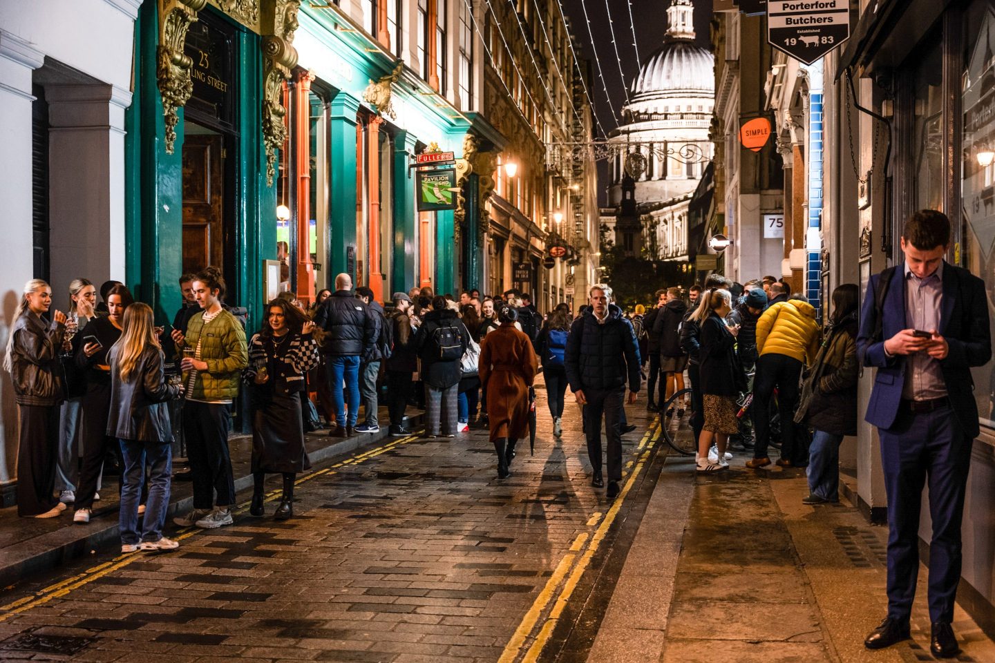 Costumers outside The Pavilion End pub, near St. Paul's Cathedral in the City of London, UK.