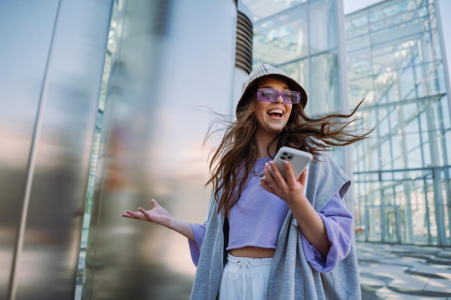 Smiling young woman in trendy clothes
