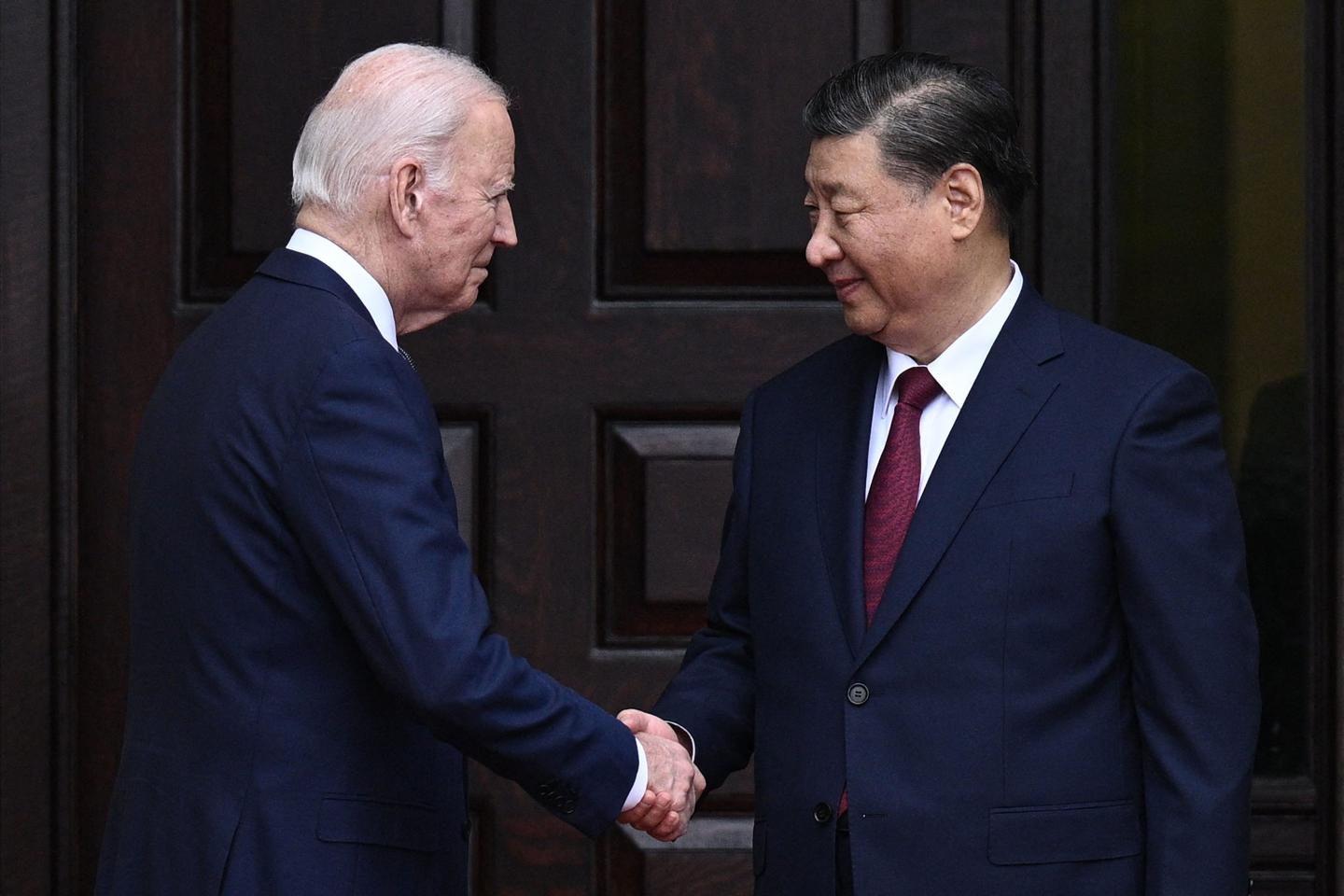 U.S. President Joe Biden greets Chinese President Xi Jinping.