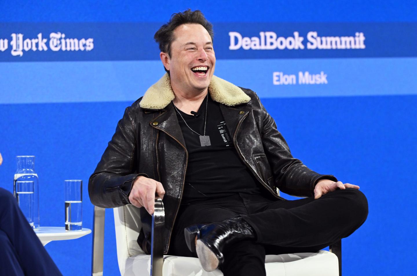 Elon Musk laughing on stage