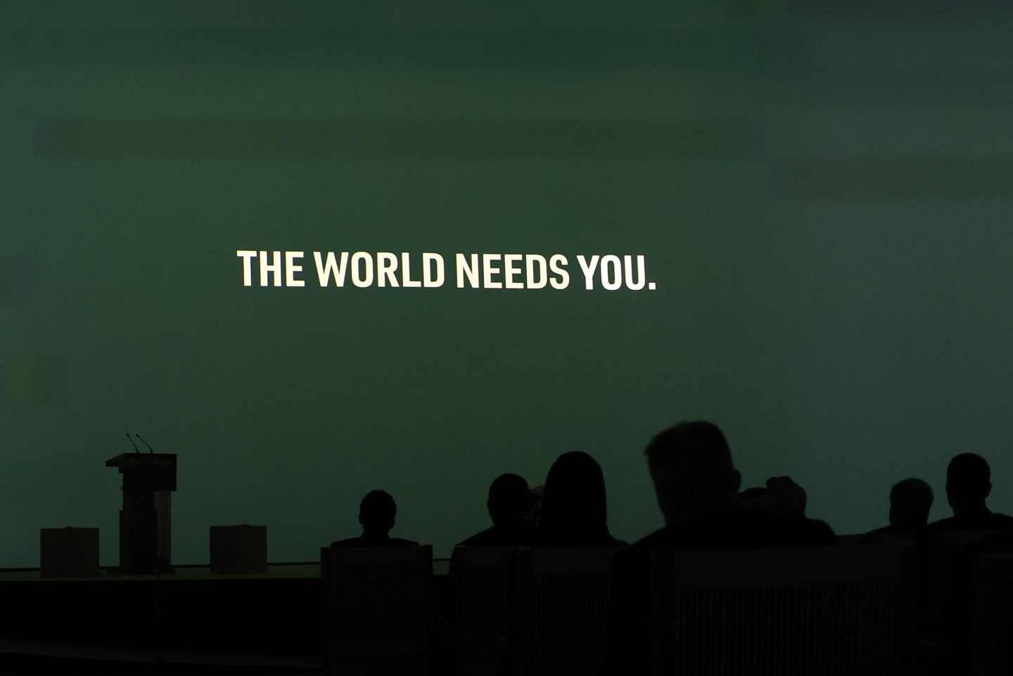 The words "The World Needs You" are projected on a screen at the opening ceremony of the World Climate Action Summit during COP28 in Dubai on Dec.1.
