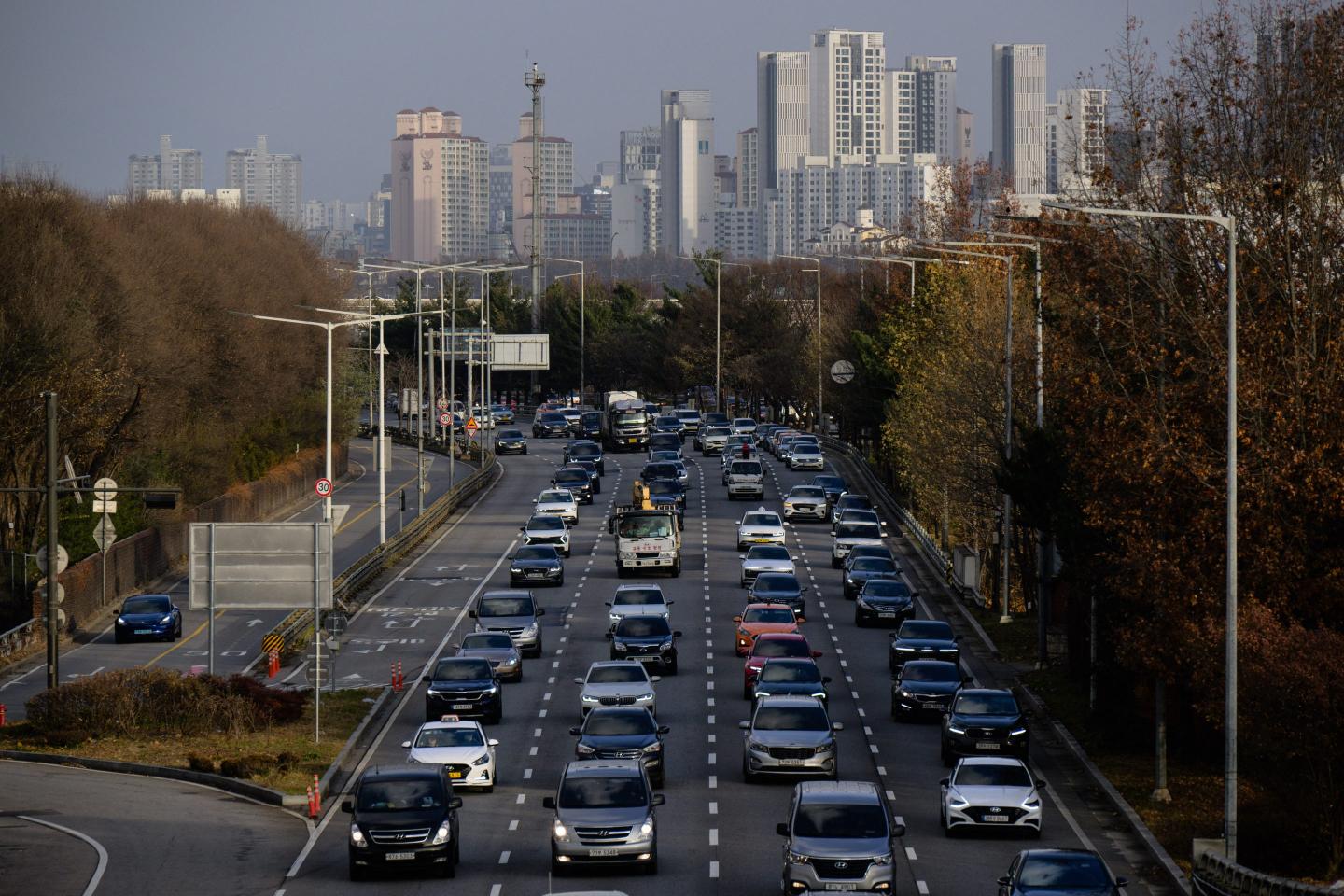 A general view shows buildings in the distance as commuters drive their cars along a main road in Seoul