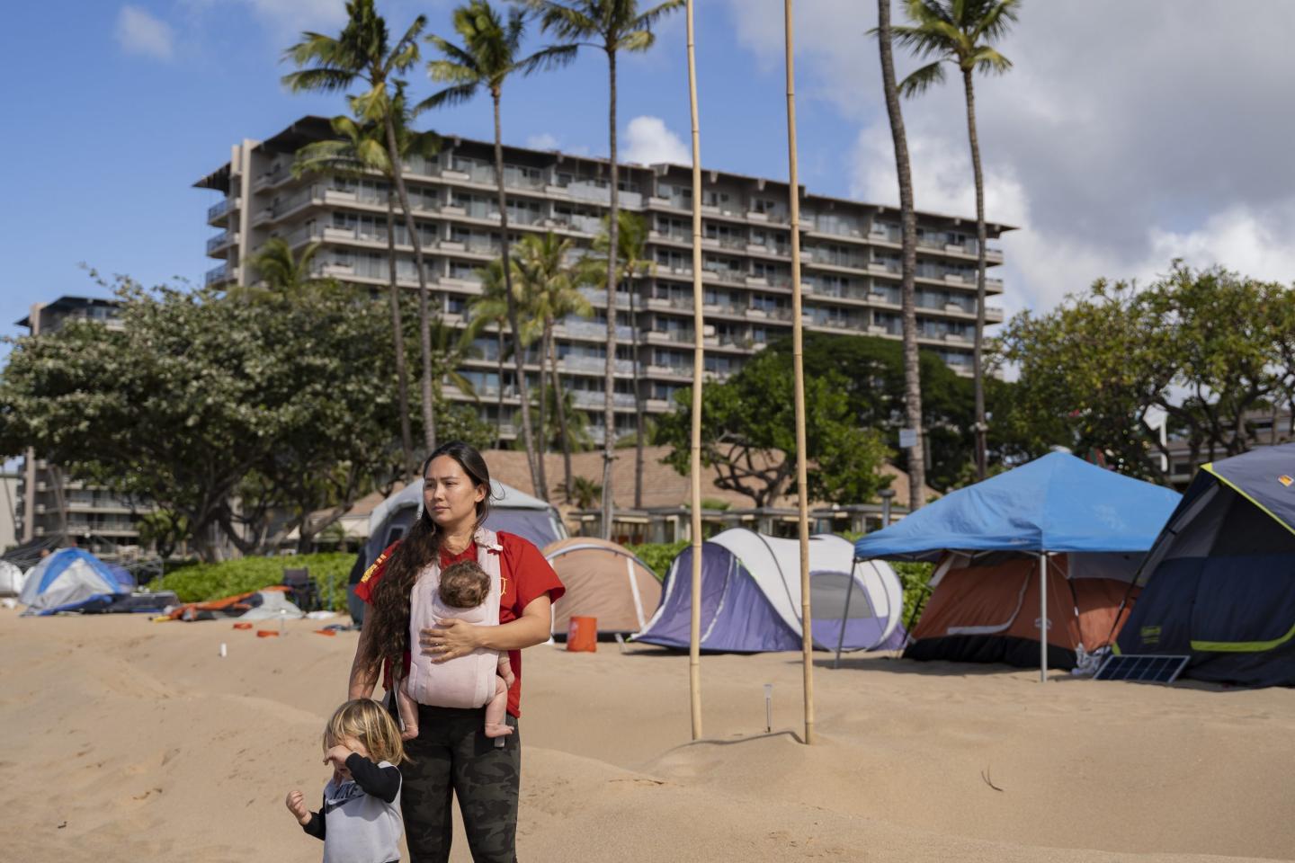 Jordan Ruidas, back, one of the organizers with Lahaina Strong, an organization focusing on helping families affected by Lahaina wildfire, poses for a portrait with her children, La'iku, left, and Waiaulia in front of the Fishing for Housing protest camp in Lahaina, Hawaii
