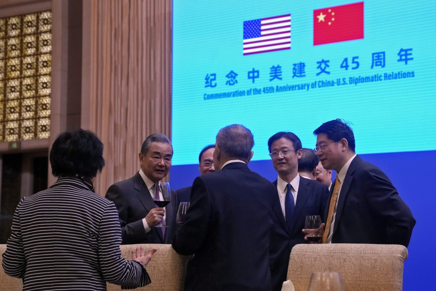 Chinese Foreign Minister Wang Yi, second left, toasts with invited guests after delivering a speech at a reception for Commemoration of the 45th Anniversary of China-U.S. Diplomatic Relations at the Diaoyutai Guest House in Beijing on Jan. 5.