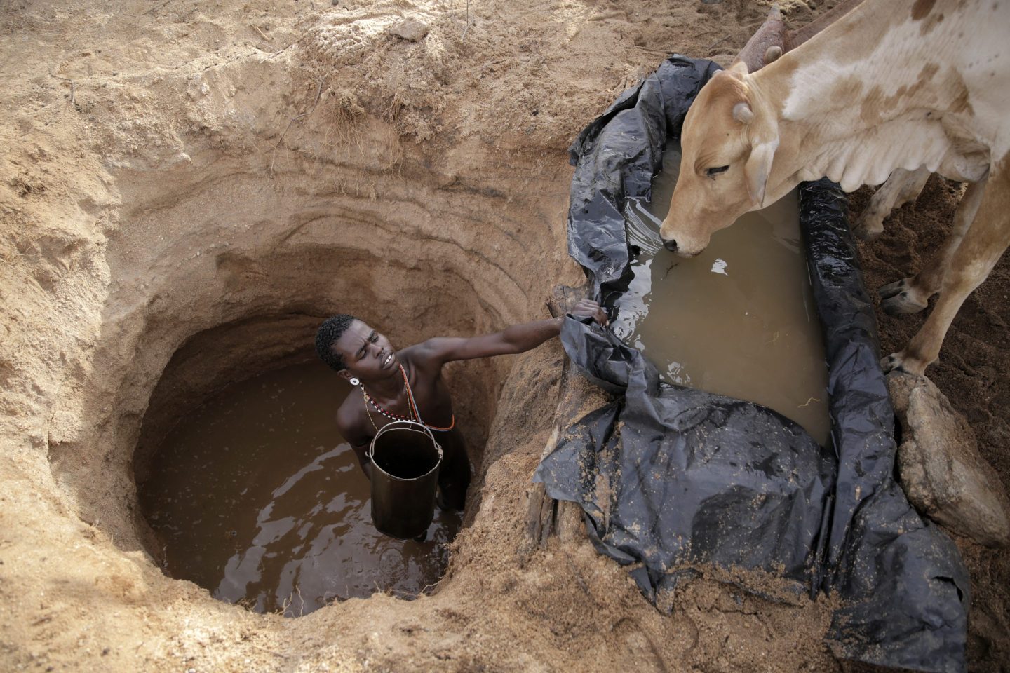 Man standing in large hole in the ground