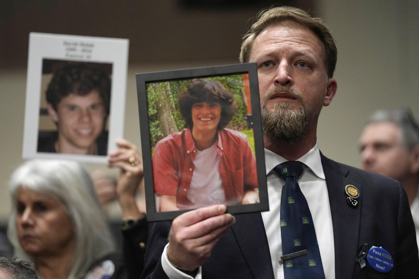 People hold photos of their loved ones as they sit in the audience before the start of a Senate Judiciary Committee hearing with the heads of social media platforms on Capitol Hill in Washington, D.C., on Wednesday to discuss child safety. (AP Photo/Susan Walsh)