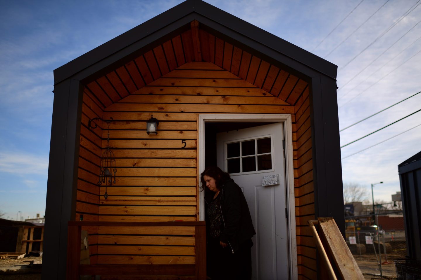 Photo of a person entering a tiny house