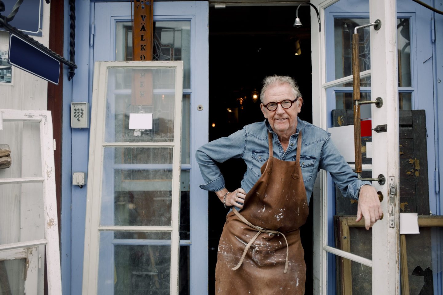 Photo of senior man at the door of a hardware store