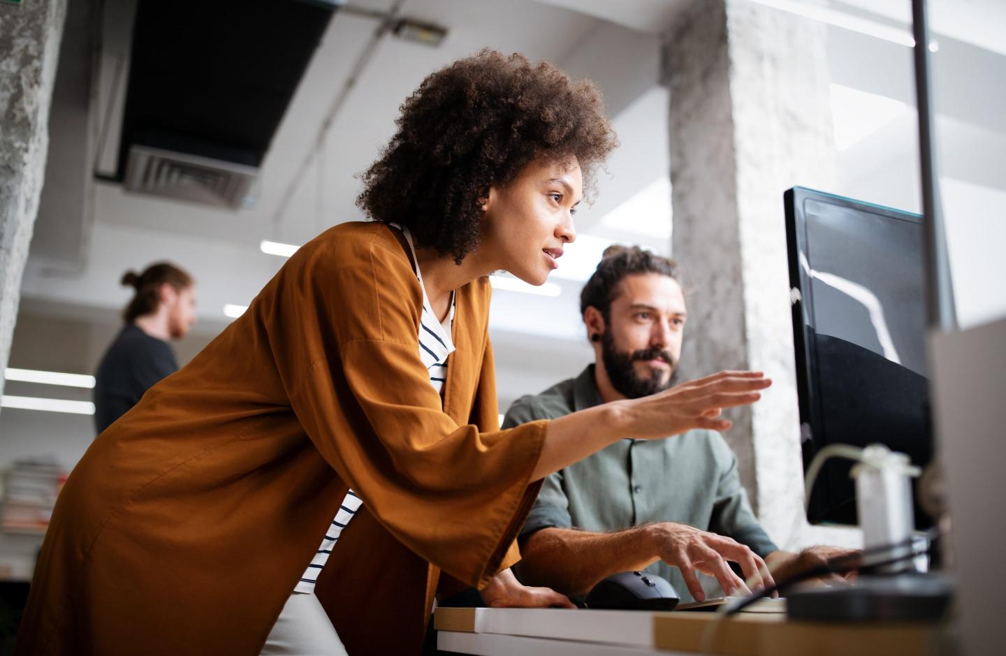 Two programmers in an office working together