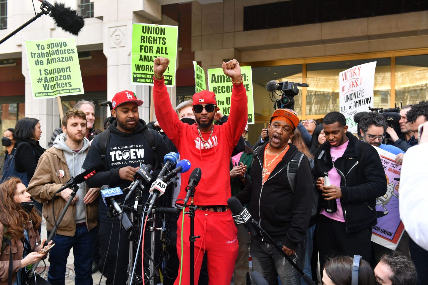 Union organizer Christian Smalls (C) celebrates as he speaks following the April 1, 2022, vote for the unionization of the Amazon Staten Island warehouse in New York.