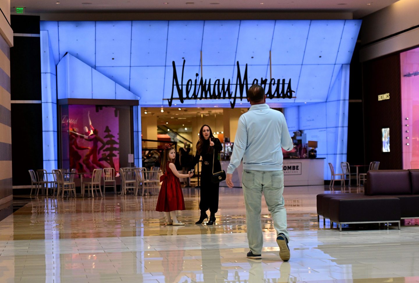 KING OF PRUSSIA, PA - DECEMBER 11: A woman holds the hand of her daughter while motioning to a man in front of Neiman Marcus at the King of Prussia Mall on December 11, 2022 in King of Prussia, Pennsylvania. The country's largest retail shopping space, the King of Prussia Mall, a 2.7 million square feet shopping destination with more than 400 stores, is owned by Simon Property Group. (Photo by Mark Makela/Getty Images)