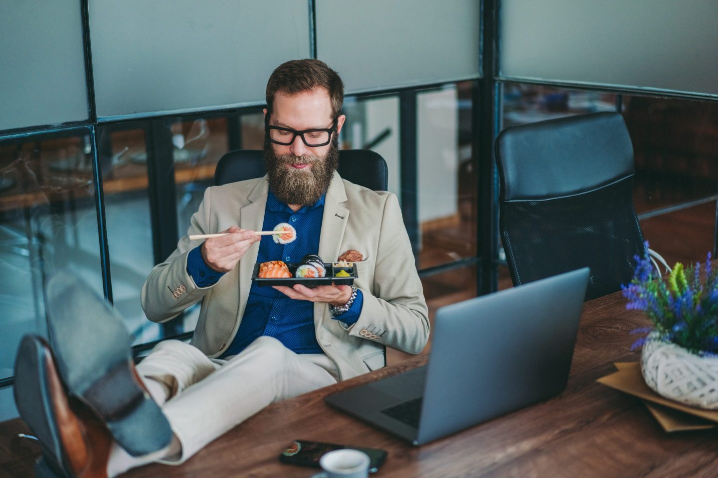 Businessman eating sushi at work
