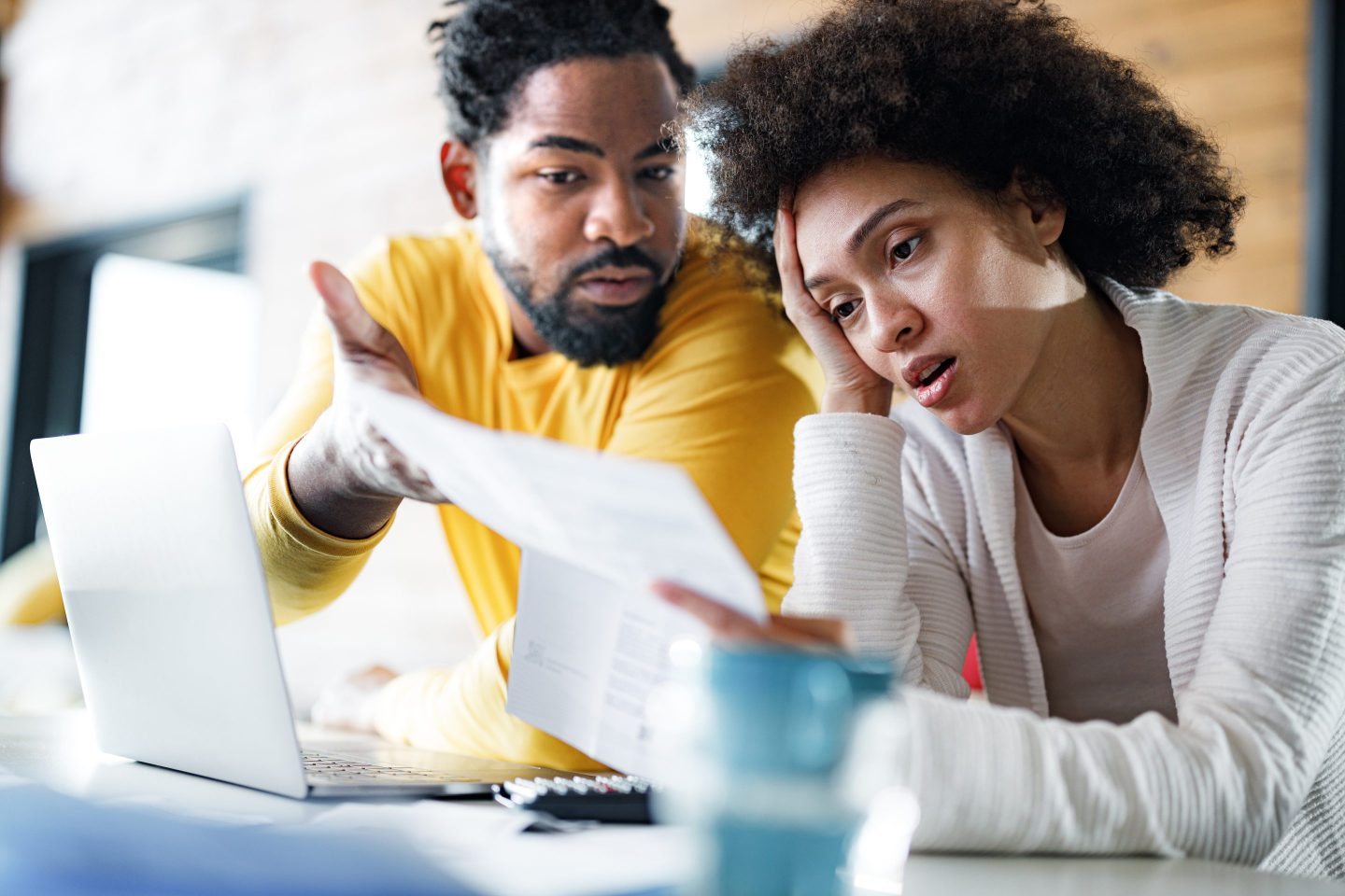 Young couple looking stressed over finances