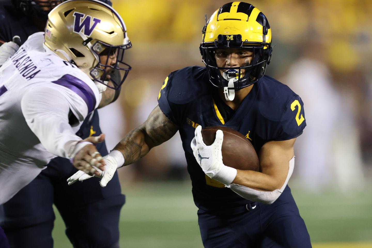 A Michigan player versus a Washington player during a game in 2021 in Ann Arbor