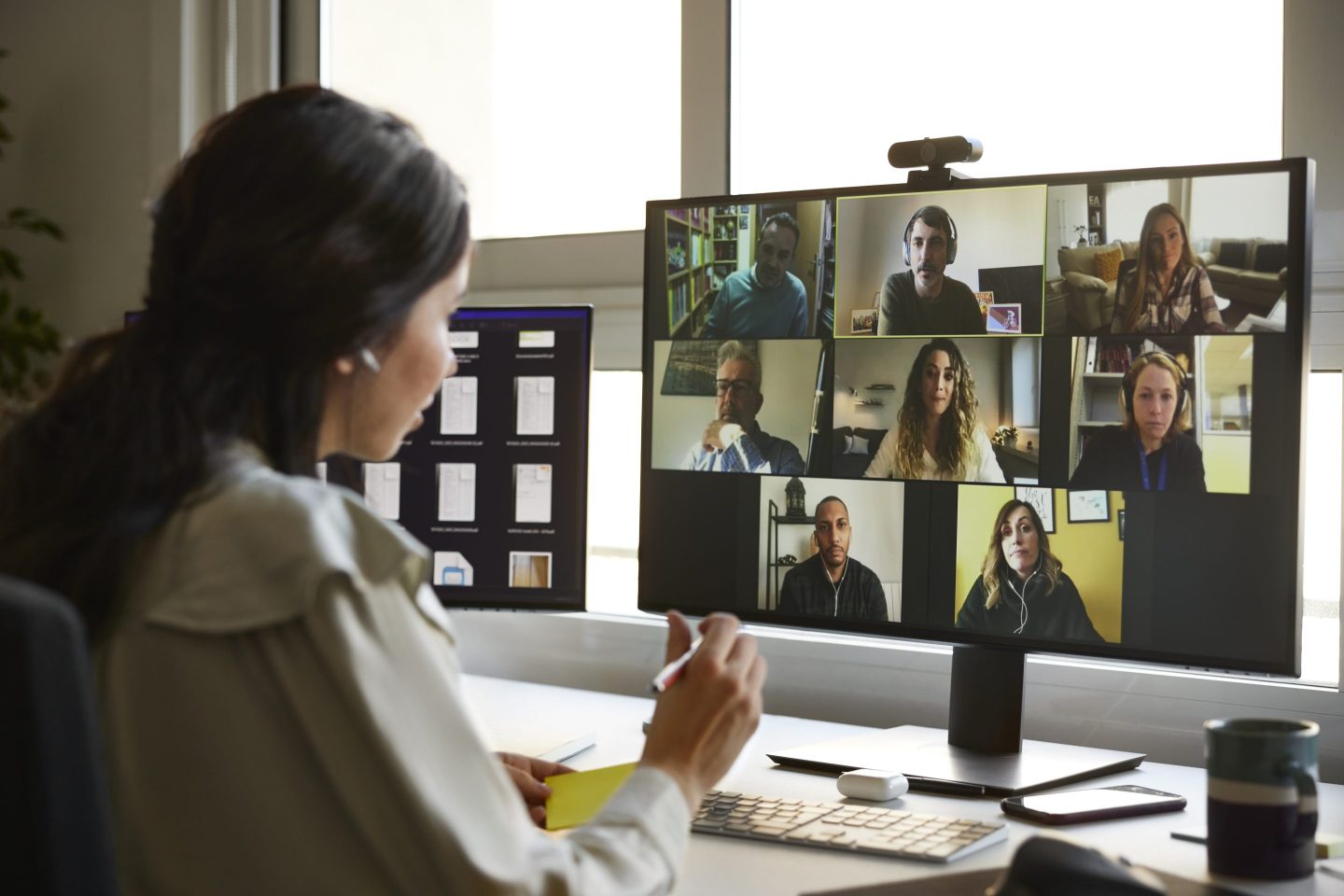 Businesswoman discussing with colleagues during video conference.
