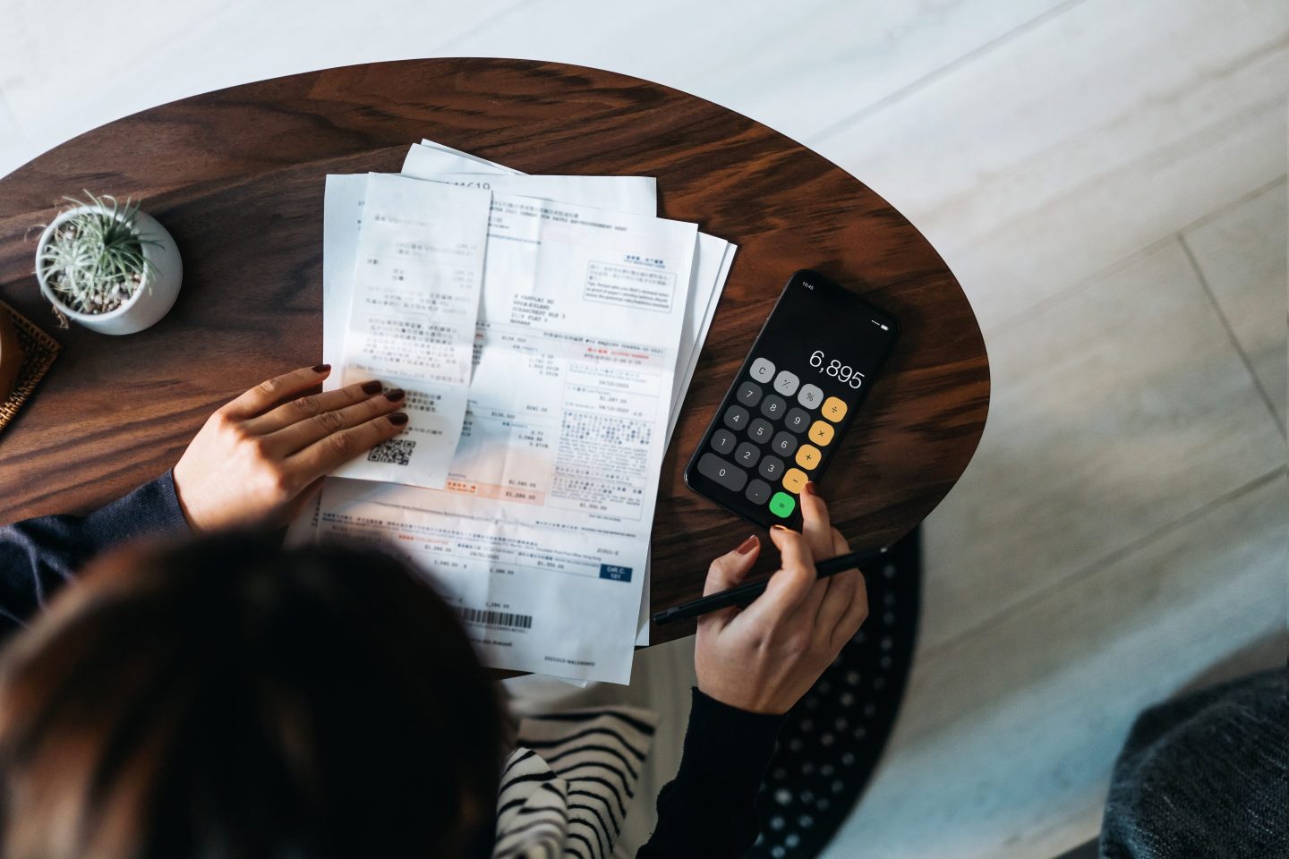 Overhead shot of woman looking at finance paperwork