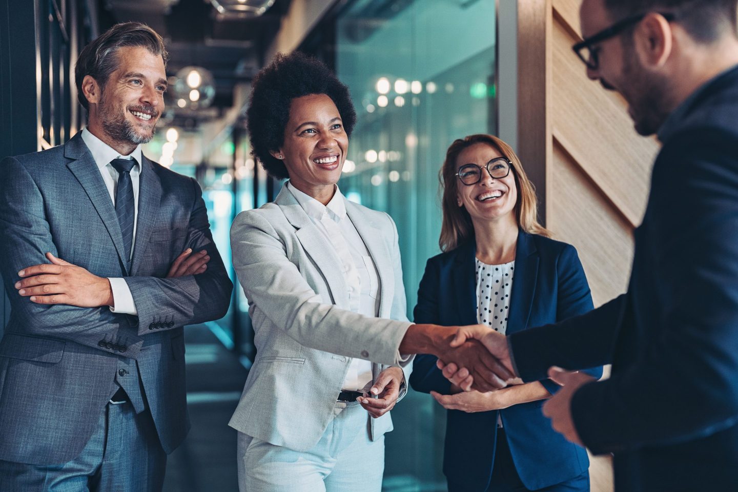 Group of business persons shaking hands in the office.