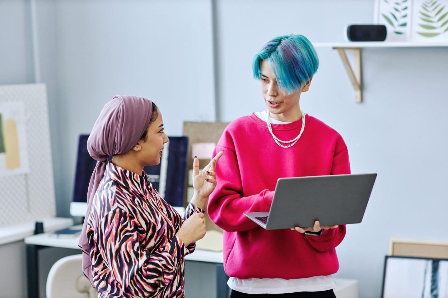 Portrait of creative Gen Z team discussing project in an office