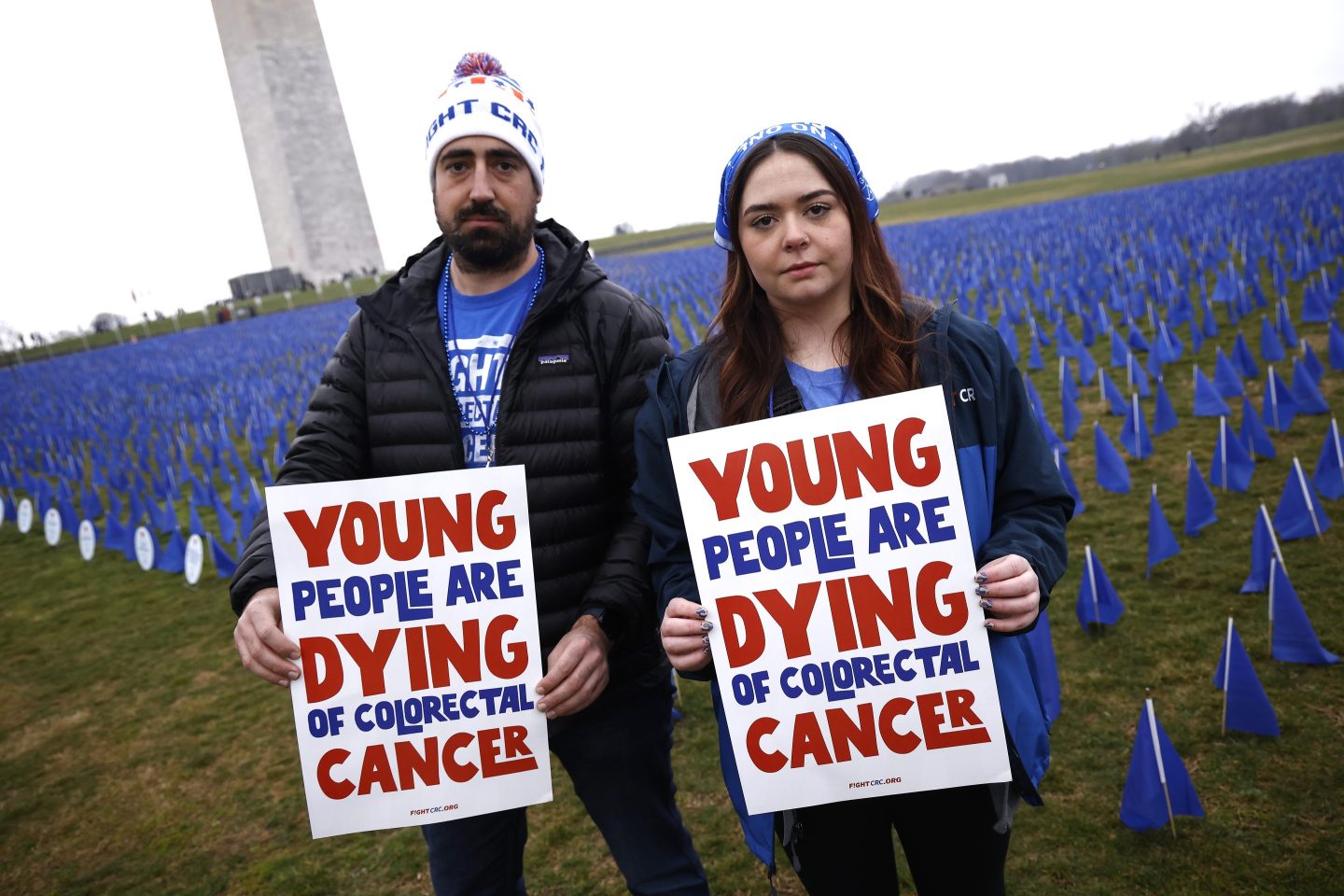 Activists pose at a colorectal cancer awareness installation on the National Mall showcasing the increasing number of cases in young adults on March 13, 2023, in Washington, D.C. The installation was a visual representation of more than 27,400 people under the age of 50 estimated to be diagnosed with colorectal cancer in 2030.