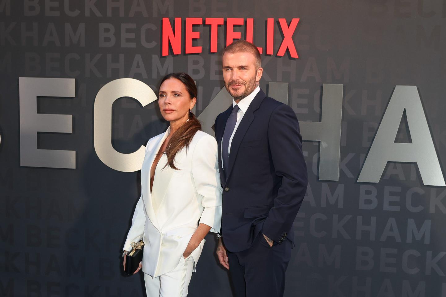 woman in white suit, man in black suit