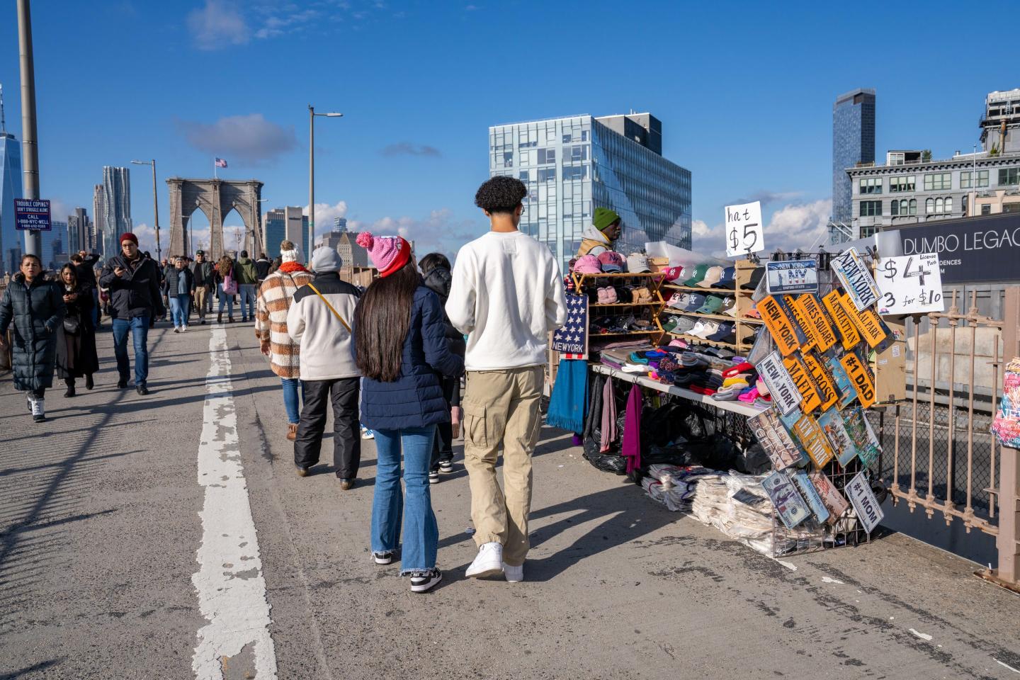 Illegal street vendors and large crowds of people are seen here on the Brooklyn side of the Brooklyn Bridge