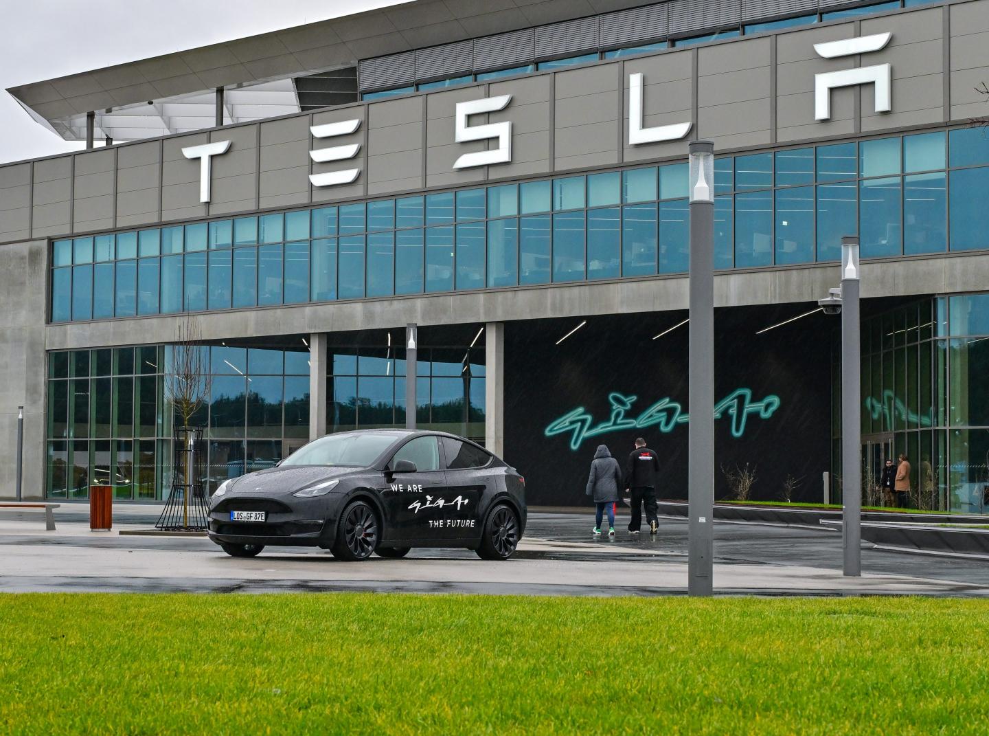 A Tesla Model Y electric vehicle stands in front of the Tesla Gigafactory Berlin