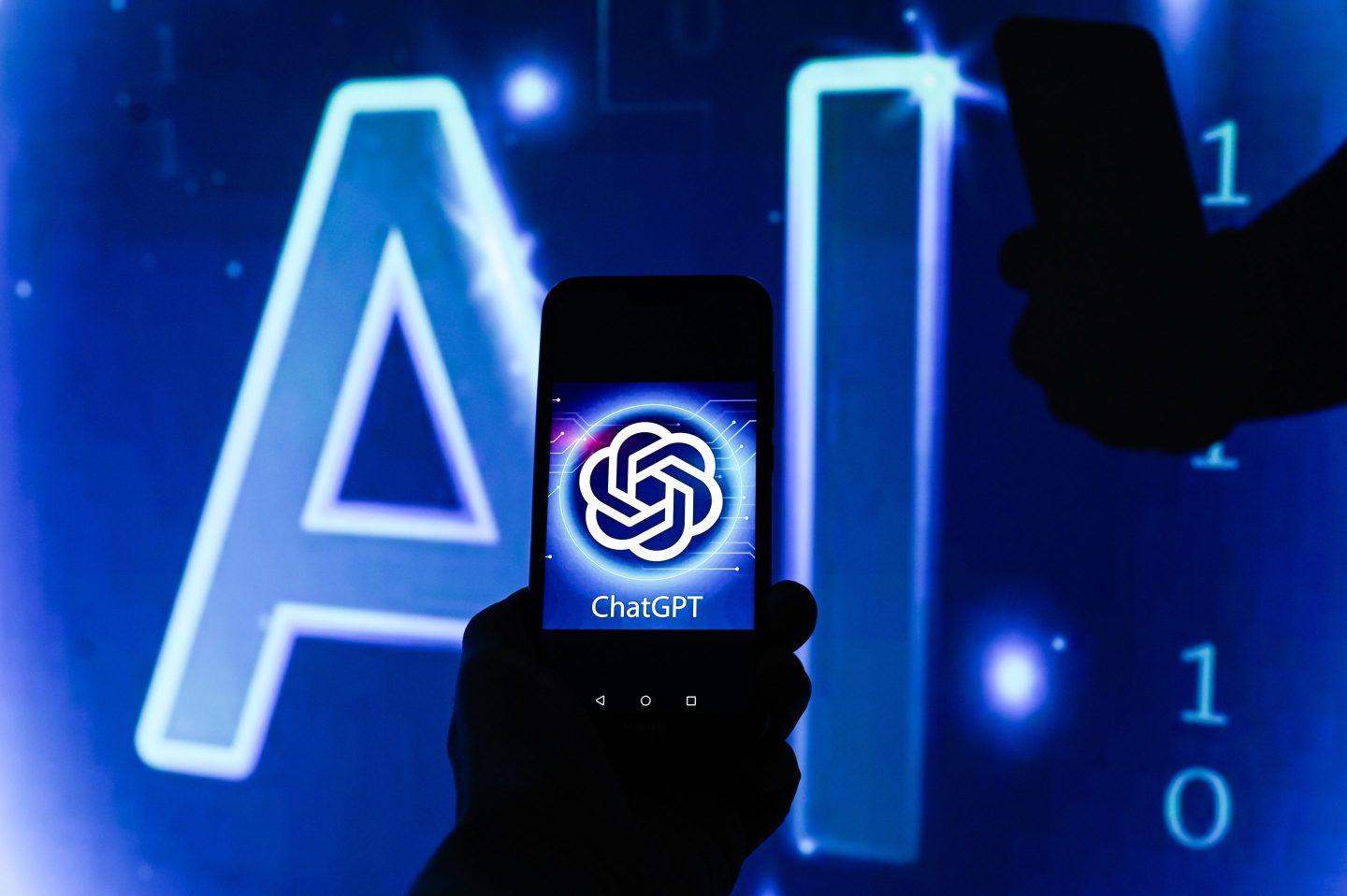 Chat GPT logo is displayed on a smartphone with Artificial Intelligence (AI) symbol on the background.