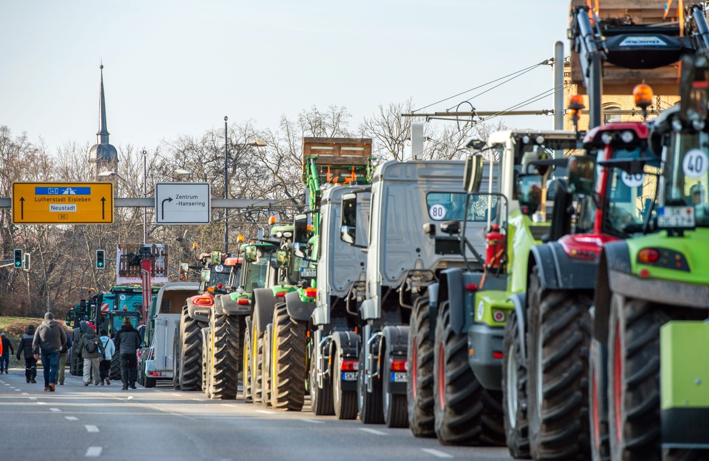 a line of trucks stand on a road