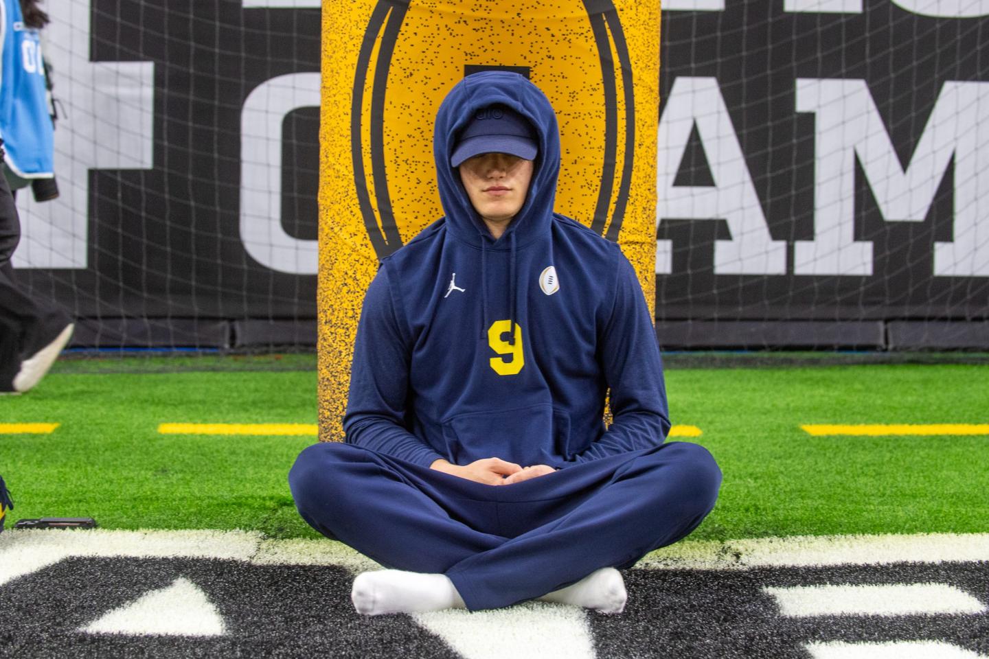 Michigan quarterback J.J. McCarthy meditates before the 2024 CFP National Championship game against the Washington Huskies at NRG Stadium on January 08, 2024 in Houston, Texas. 