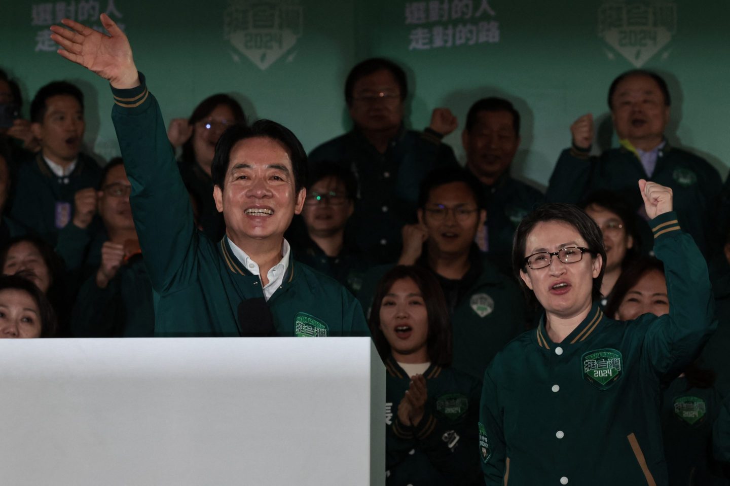 Taiwan's president-elect Lai Ching-te (L) waves besides his runningm ate Hsiao Bi-khim during a rally outside the headquarters of the DPP in Taipei on Jan. 13, 2024 after winning the presidential election.
