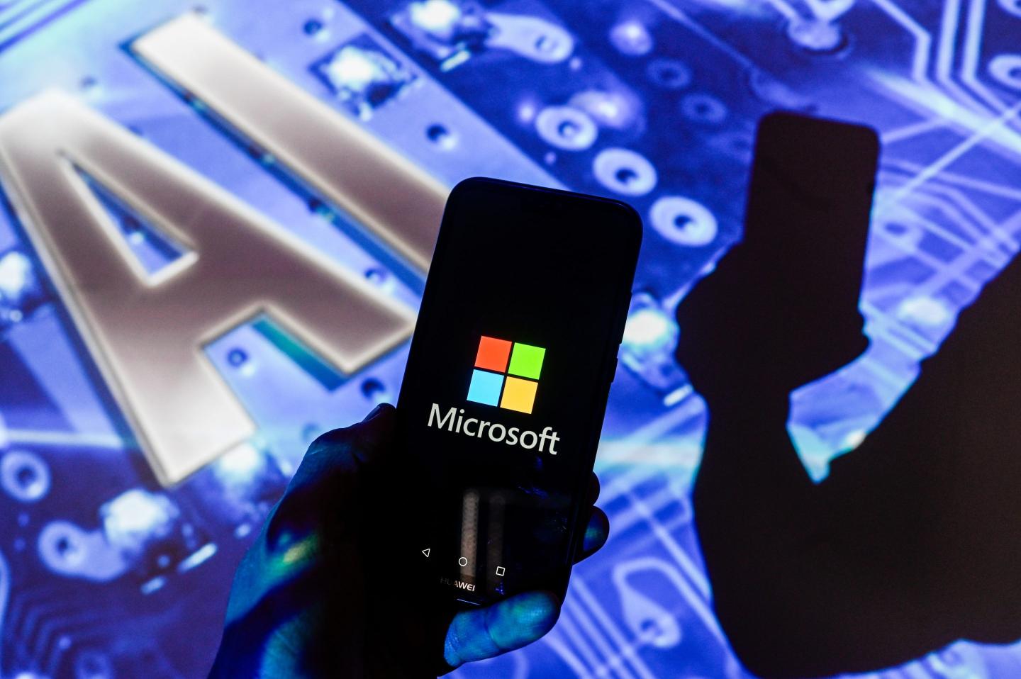 a Microsoft logo is displayed on a smartphone