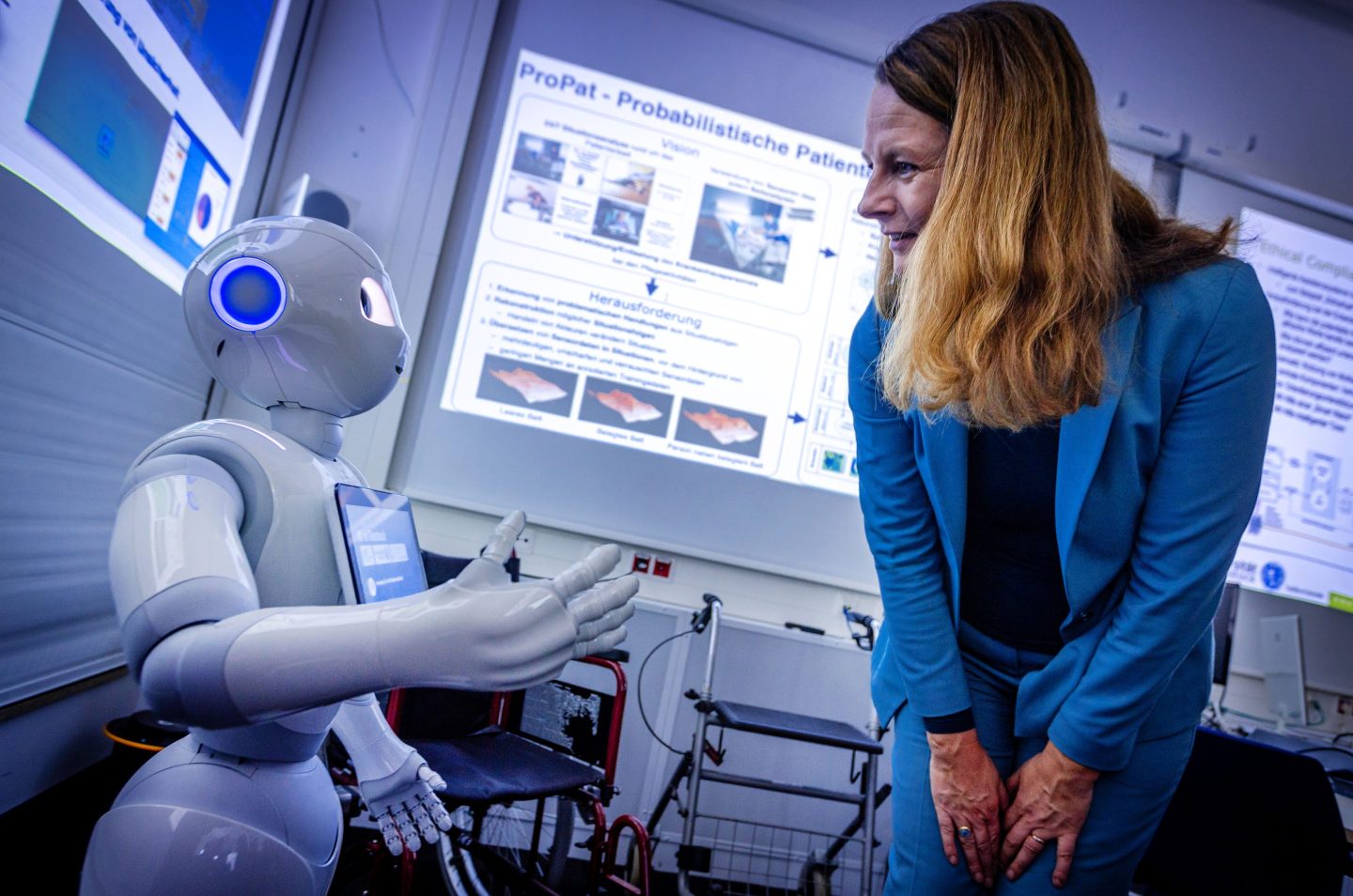 Bettina Martin (SPD), the Minister of Science and European Affairs of Mecklenburg-Vorpommern, Germany, is greeted by the Pepper robot during a visit to the Center for Artificial Intelligence at the University of Rostock.