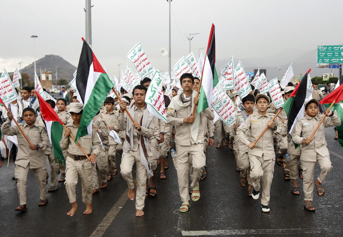 Yemen's Houthi-affiliated boys hold flags of Palestine and the Houthi emblem march during a protest held to condemn the  U.S. for redesignating Houthis as a global terrorist group, and against the U.S.-British aerial attacks conducted on Yemen on January 19, 2024, in Sana'a, Yemen. 