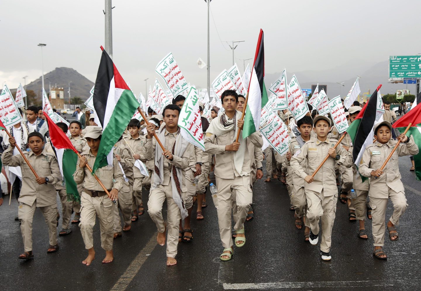Yemen's Houthi-affiliated boys hold flags of Palestine and the Houthi emblem march during a protest held to condemn the U.S. for redesignating Houthis as a global terrorist group, and against the U.S.-British aerial attacks conducted on Yemen on January 19, 2024, in Sana'a, Yemen.