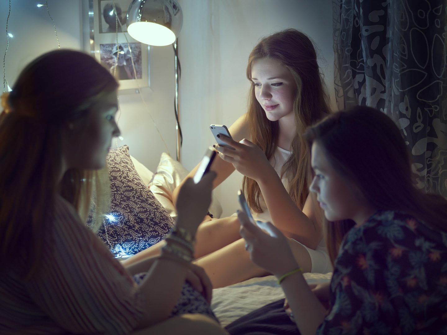 teenage girls on their phones