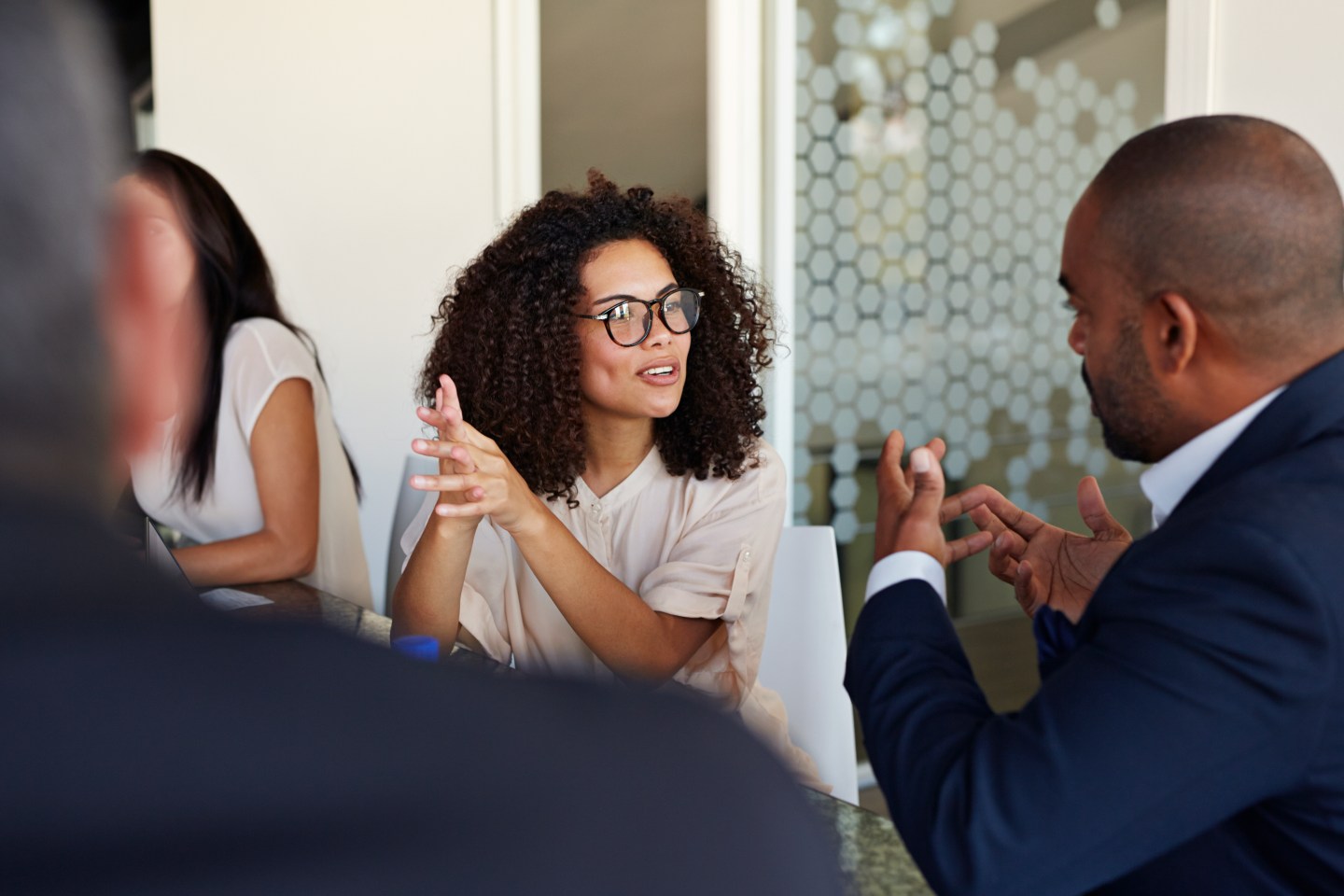 Two businesspeople in a meeting at work.