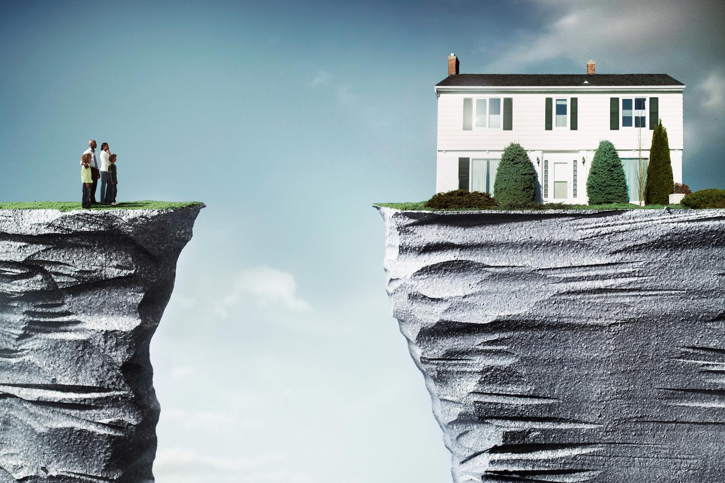 Family standing looking at house between on another cliff they cannot reach