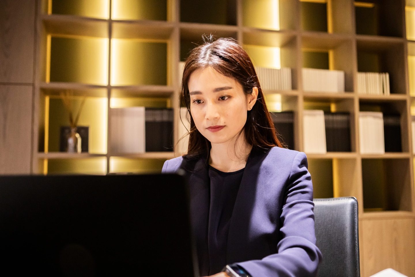 A woman checks documents in her modern office.