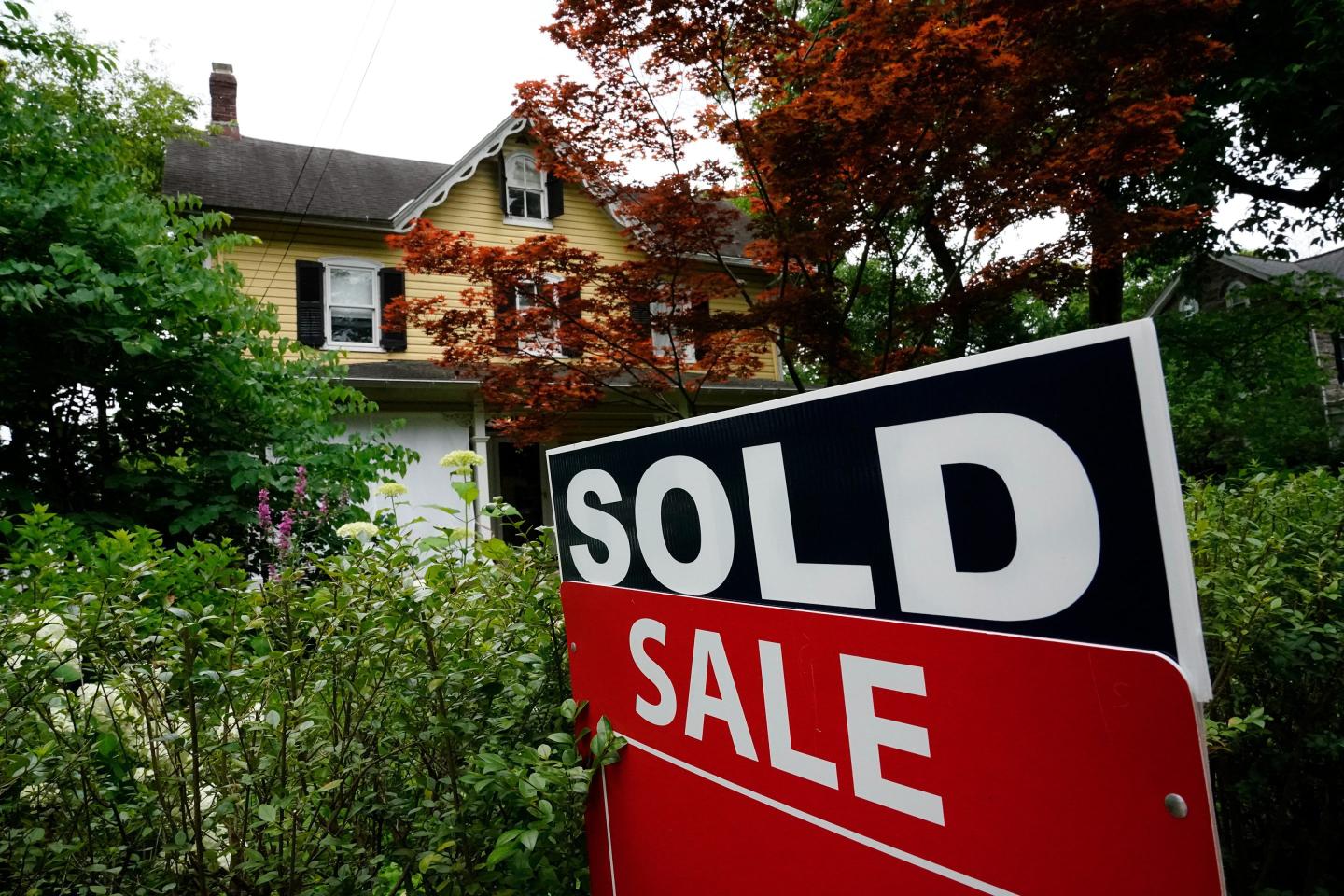 A sale sign stands outside a home in Wyndmoor, Pa., June 22, 2022.